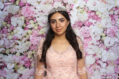 Quinceañera smiling  in the Centennial photo booth 